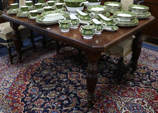 An Edwardian walnut wind-out dining table, one extra leaf, L.148cm